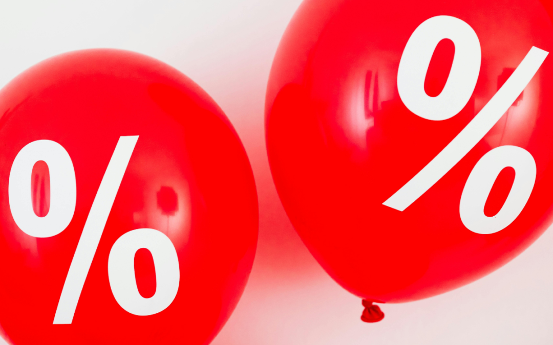 Two red balloons with percentage signs in white floating against a white backdrop to represent things that help boost book sales.