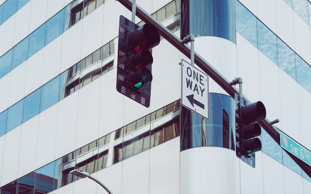 A city traffic light and a one-way sign to represent how to get more website traffic by factoring in search intent.